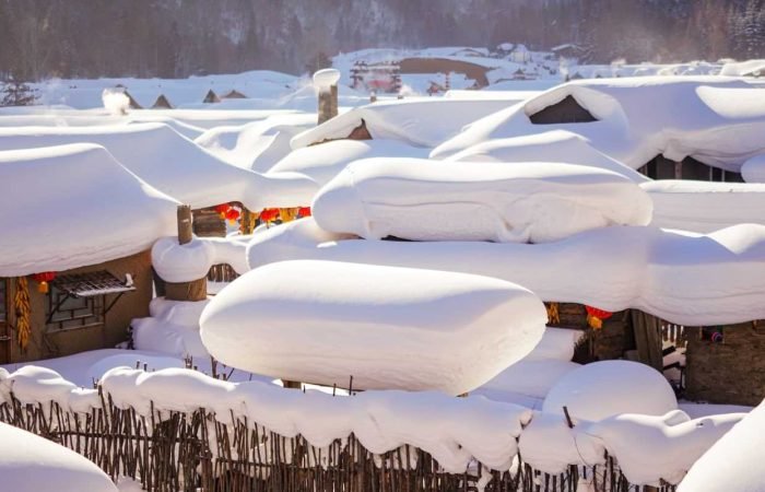 A town near Harbin called Snow Town, with wooden houses topped with a thick pack snow.
